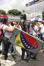 Anti Nicolas Maduro protesters wearing tear-gas mask during mass demonstrations that turned into riots in Caracas, Venezuela.