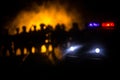 Anti-riot police give signal to be ready. Government power concept. Police in action. Smoke on a dark background with lights. Blue Royalty Free Stock Photo