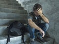 Campaign vs homophobia with young sad and depressed college student man sitting on staircase desperate victim of harassment