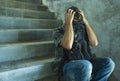 Campaign vs homophobia with young sad and depressed college student man sitting on staircase desperate victim of harassment