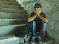 Campaign vs homophobia with young sad and depressed college student man sitting on staircase desperate victim of harassment