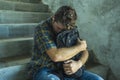 Campaign vs homophobia with young sad and depressed college student man sitting on staircase desperate victim of harassment