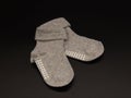 Slip-resistant baby grey socks isolated in black background.