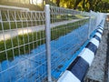 Anti snatch thief fencing is installed on sidewalks to prevent snatch theft. Royalty Free Stock Photo