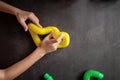 anti stress sensory pop tube toys in a children`s hands. a little happy kids plays with a poptube toy on a black table. toddlers