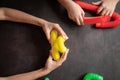 anti stress sensory pop tube toys in a children`s hands. a little happy kids plays with a poptube toy on a black table. toddlers