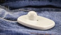 Anti-theft tag or tag, security tag with sensor and electronic warning, electronic security equipment, on denim clothing Royalty Free Stock Photo
