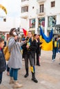 Anti-war demonstration. Female journalist is filming and making interview.