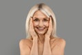 Antiage Skincare. Attractive Happy Mature Lady Touching Face And Smiling At Camera Royalty Free Stock Photo