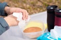 Antibacterial treatment of hands before eating in nature. the man wipes his hands with a damp cloth from viruses and bacteria.