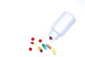 Antibiotic capsules spilling out of pill bottle isolated on white background with clipping path. Royalty Free Stock Photo