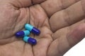 Antibiotic pills in a hand closeup