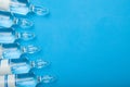 Antibiotics in glass ampoules on a blue background. Copy space