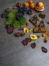 anticancer food, good for cardiovasculas system, fresh ripe grape, dark chocolate, raspberries, tomatoes, apple, beet on concrete