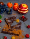 anticancer food, good for cardiovasculas system, fresh ripe grape, dark chocolate, raspberries, tomatoes, apple on concrete