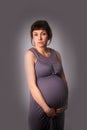 Anticipation baby beautiful pregnant brunette woman in a gray dr