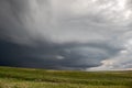 An anticyclonic supercell thunderstorm hangs in the sky over the high plains.