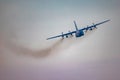 Antidotum Airshow Leszno 2023 and acrobatic shows full of smoke of C-130 Hercules plane on a cloudy