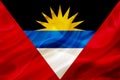 Antigua and Barbuda country flag on silk or silky waving texture Royalty Free Stock Photo