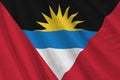 Antigua and Barbuda flag with big folds waving close up under the studio light indoors. The official symbols and colors