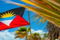 Antigua and Barbuda Flag on a Caribbean Beach with Palms Royalty Free Stock Photo