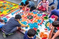 Children decorate dyed sawdust Good Friday carpet, Antigua, Guatemala Royalty Free Stock Photo