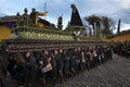 Women dressed in black carrying a giant float in a street of the old city of Antigua during a procession of the Holy Week, in Anti