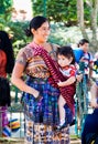 Guatamalian woman with baby carry at her in Antigua, Guatemala.