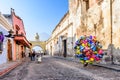 Balloon seller in street with Santa Catalina arch, ruins & volcano, Antigua, Guatemala Royalty Free Stock Photo