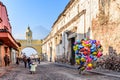 Balloon seller in street with Santa Catalina arch, ruins & volcano, Antigua, Guatemala Royalty Free Stock Photo