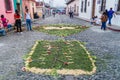 ANTIGUA, GUATEMALA - MARCH 26, 2016: People walk along decorative Easter carpets in Antigua Guatemala town, Guatemal Royalty Free Stock Photo