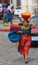 Portrait of a Mayan woman carring fruits on her head.