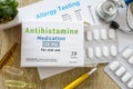 Antihistamine medication or allergy drug concept photo. On doctor table is pack with word `Antihistamine medication` and pills for