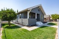 A newly remodeled house with green grass and a blue sky