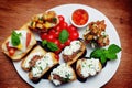 Antipasti bruschetta canape with tomatoes mozzarella basil on plate. Royalty Free Stock Photo