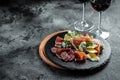 Antipasto board with sliced meat, ham, salami, cheese for red wine. Traditional Spanish meat snacks on a slate board Royalty Free Stock Photo