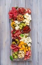 Antipasto catering platter with bacon, jerky, sausage, blue cheese and grapes Royalty Free Stock Photo