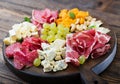 Antipasto catering platter with bacon, jerky, sausage, blue cheese and grapes Royalty Free Stock Photo