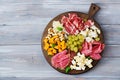 Antipasto catering platter with bacon, jerky, sausage, blue cheese and grapes Royalty Free Stock Photo