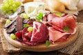 Antipasto catering platter with bacon, jerky, sausage, blue cheese and grapes Royalty Free Stock Photo