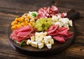 Antipasto catering platter with bacon, jerky, sausage, blue cheese and grapes Royalty Free Stock Photo