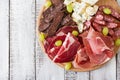 Antipasto catering platter with bacon, jerky, sausage, blue cheese and grapes Royalty Free Stock Photo