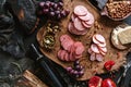 Antipasto cold meat platter with sausage, ham, salami, decorated with cheese, fruits, bottle of wine, nuts and olives on wooden Royalty Free Stock Photo