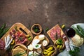 Antipasto delicatessen - meat, cheese, olives and wine on stone