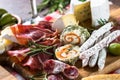 Antipasto delicatessen - meat, cheese, olives and wine on stone Royalty Free Stock Photo