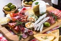 Antipasto delicatessen - meat, cheese, olives and wine on stone Royalty Free Stock Photo