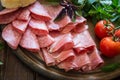 Antipasto with ham, bresaola and salami. bread, tomato and basil Royalty Free Stock Photo