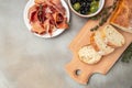 Antipasto of ham, crostini with prosciutto, olives and glass of red wine Royalty Free Stock Photo