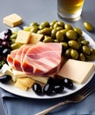 Antipasto plate with ham, cheese, olives and wine.