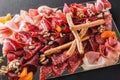 Antipasto platter cold meat with grissini bread sticks, prosciutto